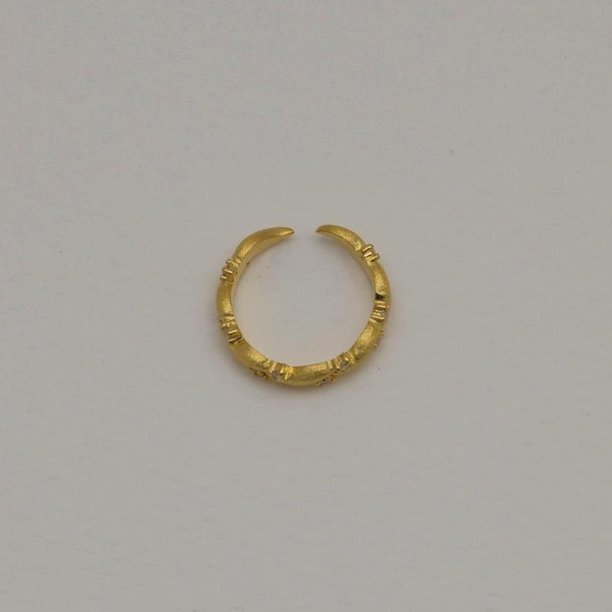 Gold vermeil pavé ring with matte finish and cubic zirconia, adjustable band shown against a white background