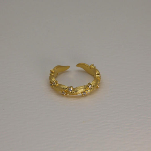 Gold vermeil pavé ring with matte finish and cubic zirconia, adjustable band shown against a white background