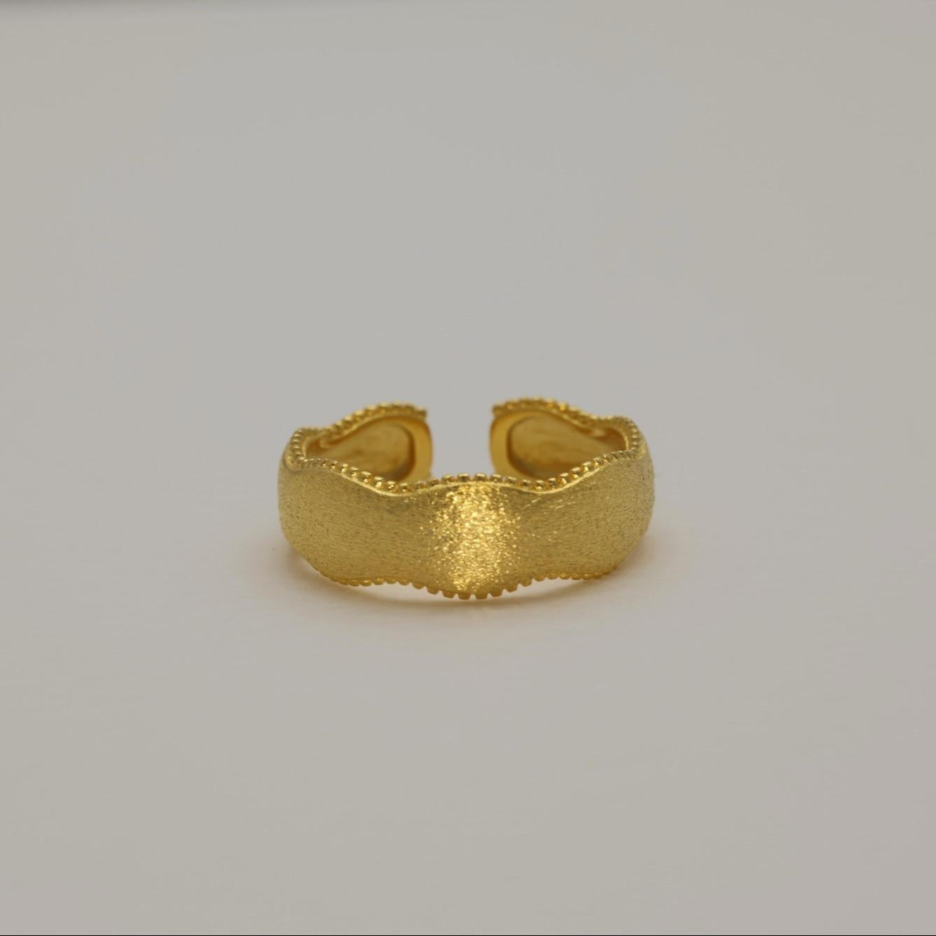 Gold vermeil wavy ring with beaded edges, front view on neutral background.
