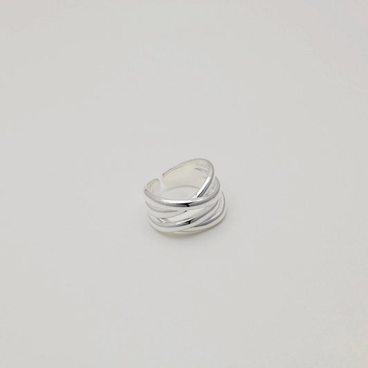 "Sculptural sterling silver ring featuring intersecting high-shine bands"