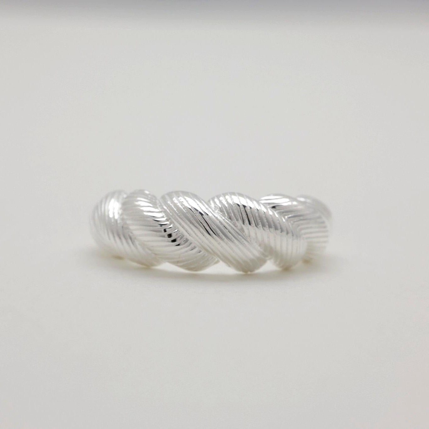 Front view of MOA's adjustable silver ring with intricate twist design