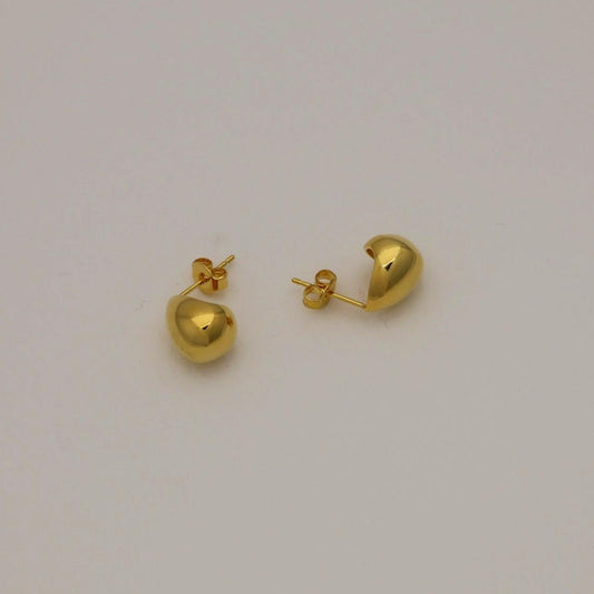 Front-facing Elva teardrop earrings in polished gold vermeil on a soft neutral background