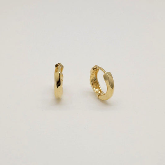 14K gold huggie earrings with softly curved silhouette, photographed on a white background.