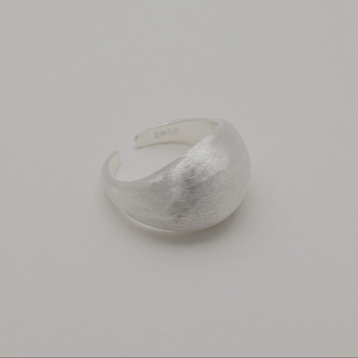 Side view of 925 sterling silver dome ring with brushed surface