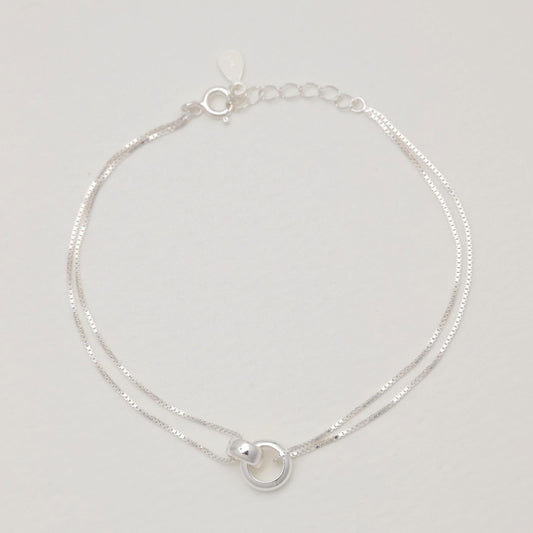 Flat lay view of the Liliane bracelet fully extended, highlighting the twin box chains and extender clasp.
