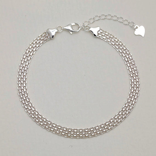 Full view of the Marcelline Bracelet showing its triple woven chain design