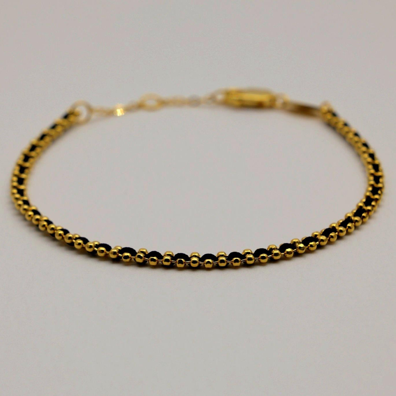Side angle of the Agnès Woven Bracelet showing its slim, polished profile.