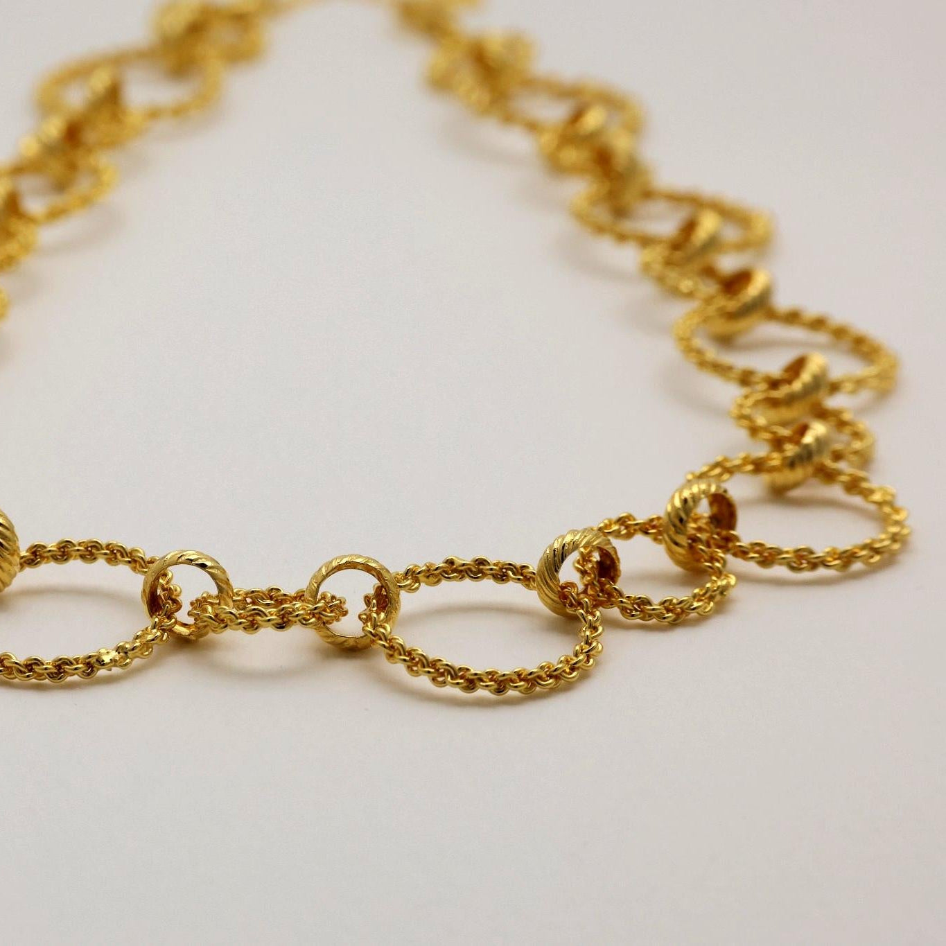 Angled view showing texture and dimensionality of gold vermeil circle links