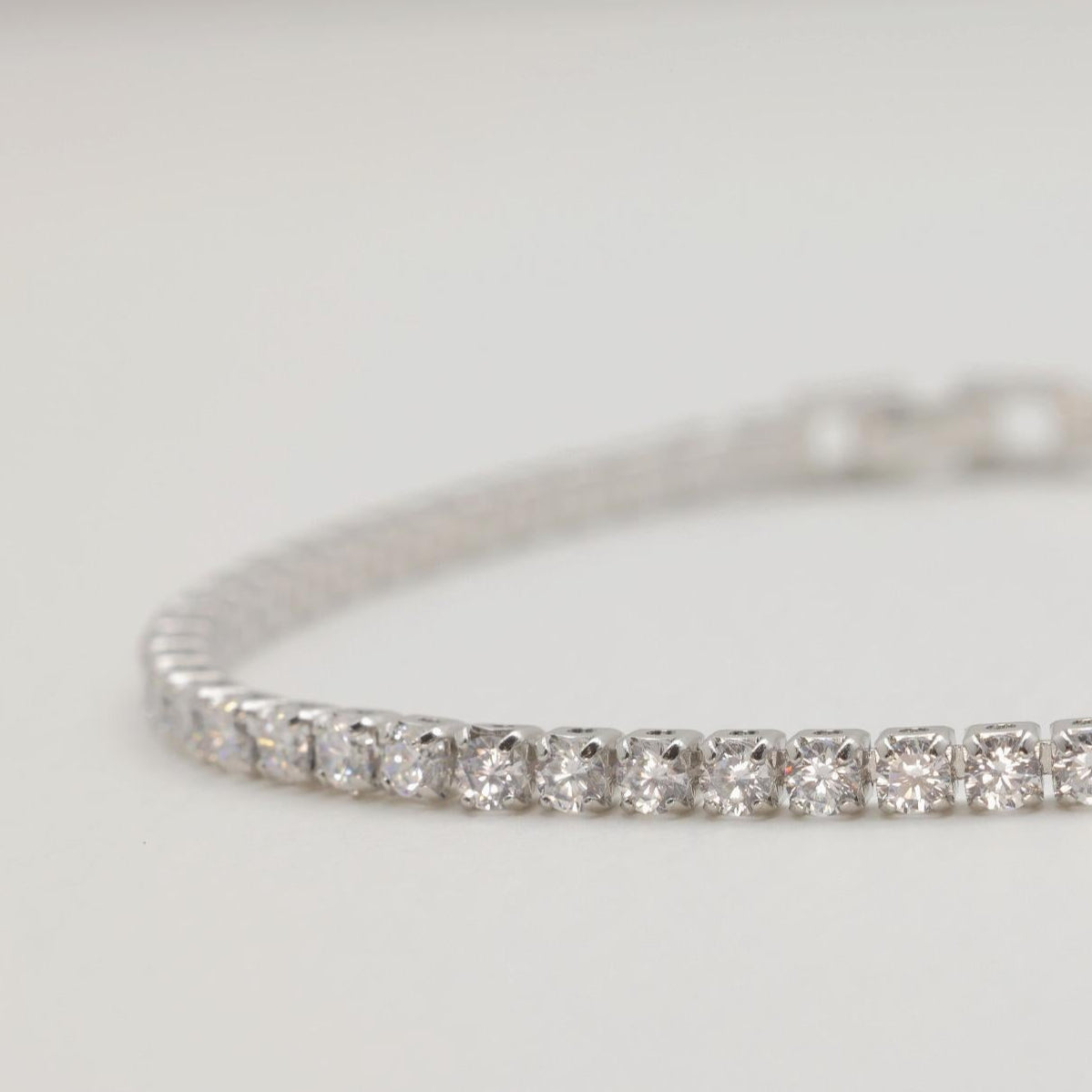 Side angle of polished silver bracelet with brilliant cubic stones

