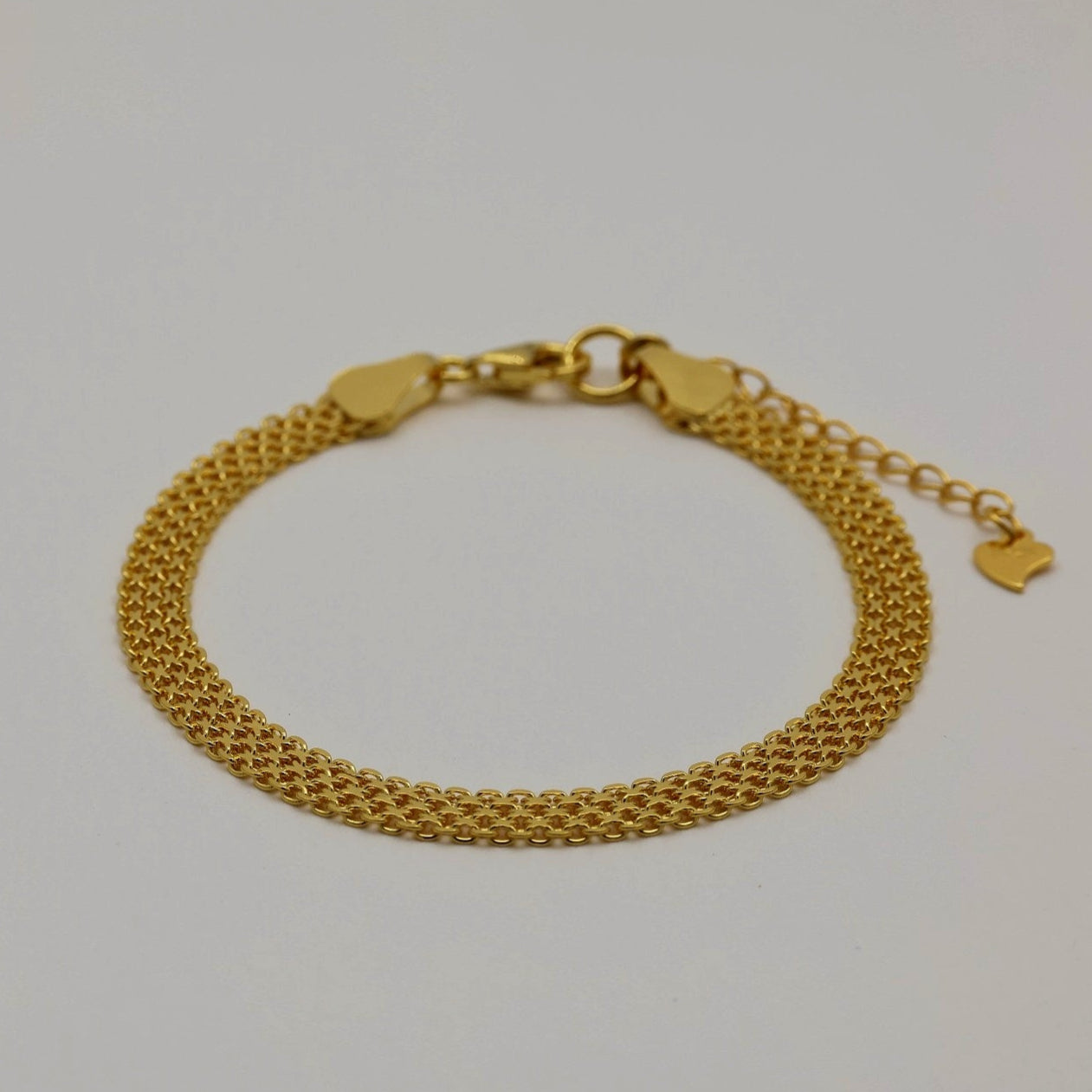Close-up view of the gold vermeil bracelet’s fine woven mesh texture, highlighting the intricate, star-like links and polished finish.

