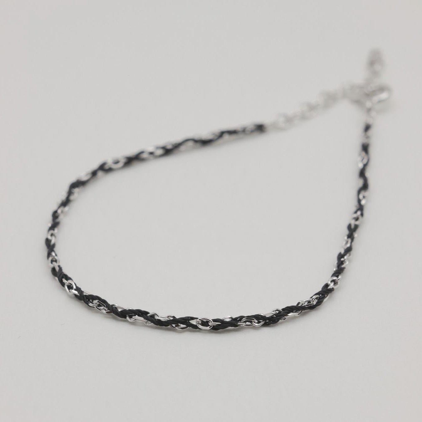 Angled view of Sabine bracelet showing contrast between polished links and cord

