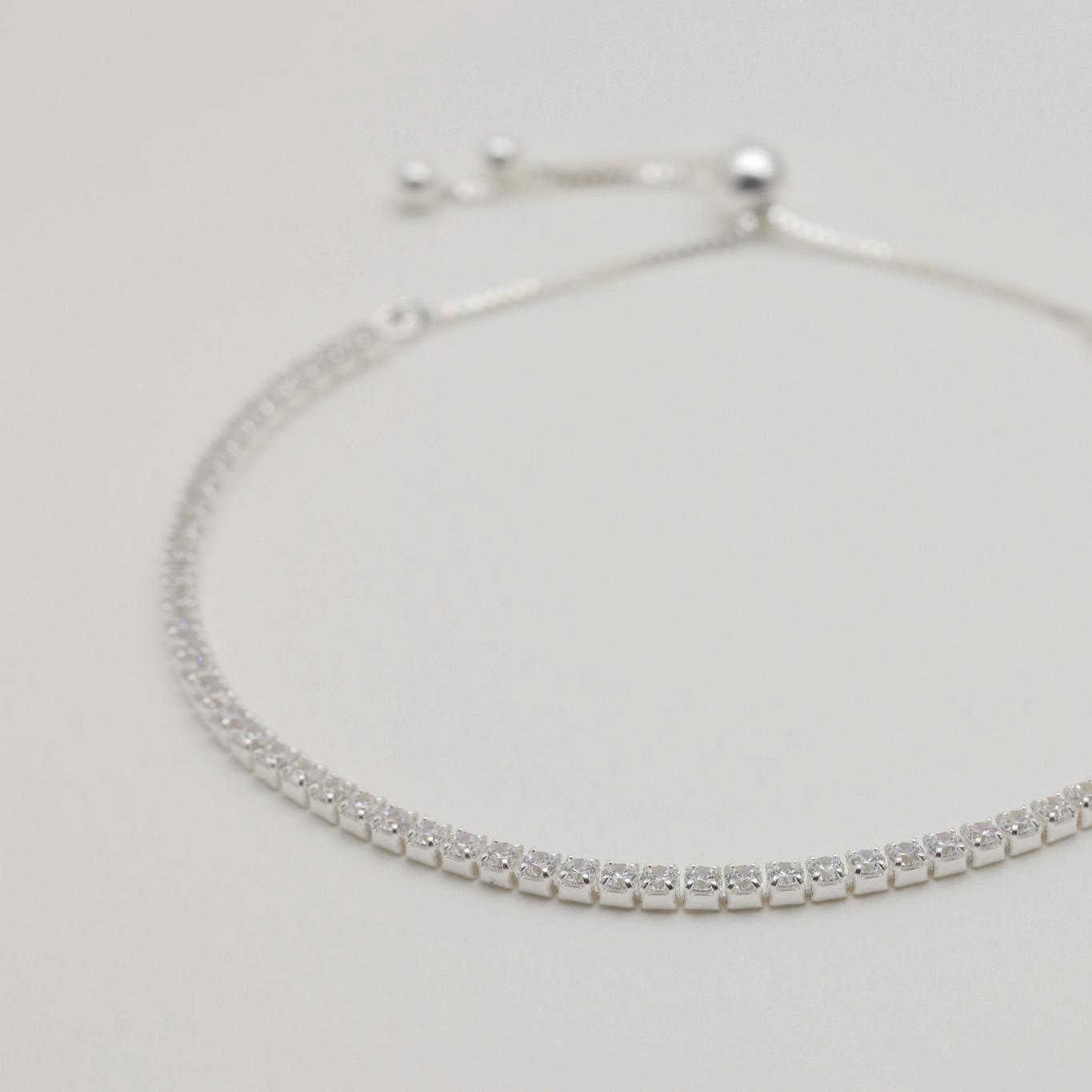 Side view of Édith bracelet showing prong-set stones and slider clasp

