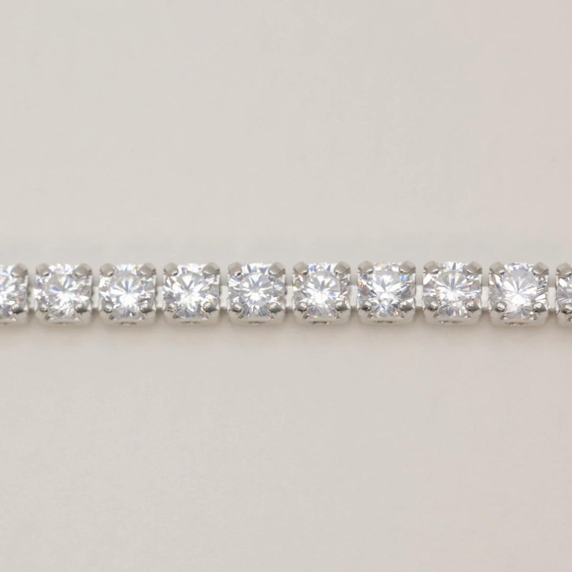 Macro detail of cubic zirconia line on silver bracelet