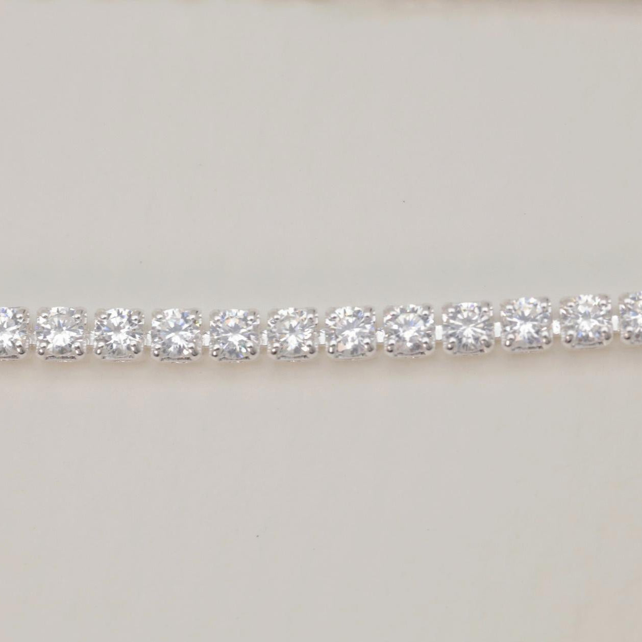 Macro detail of cubic zirconia line on silver bracelet